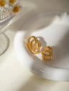 Boucles d’Oreilles Double Anneau Entrelacé en Acier Inoxydable Doré – Élégance Moderne – Écrin Offert "Lyna" Mara Bijoux